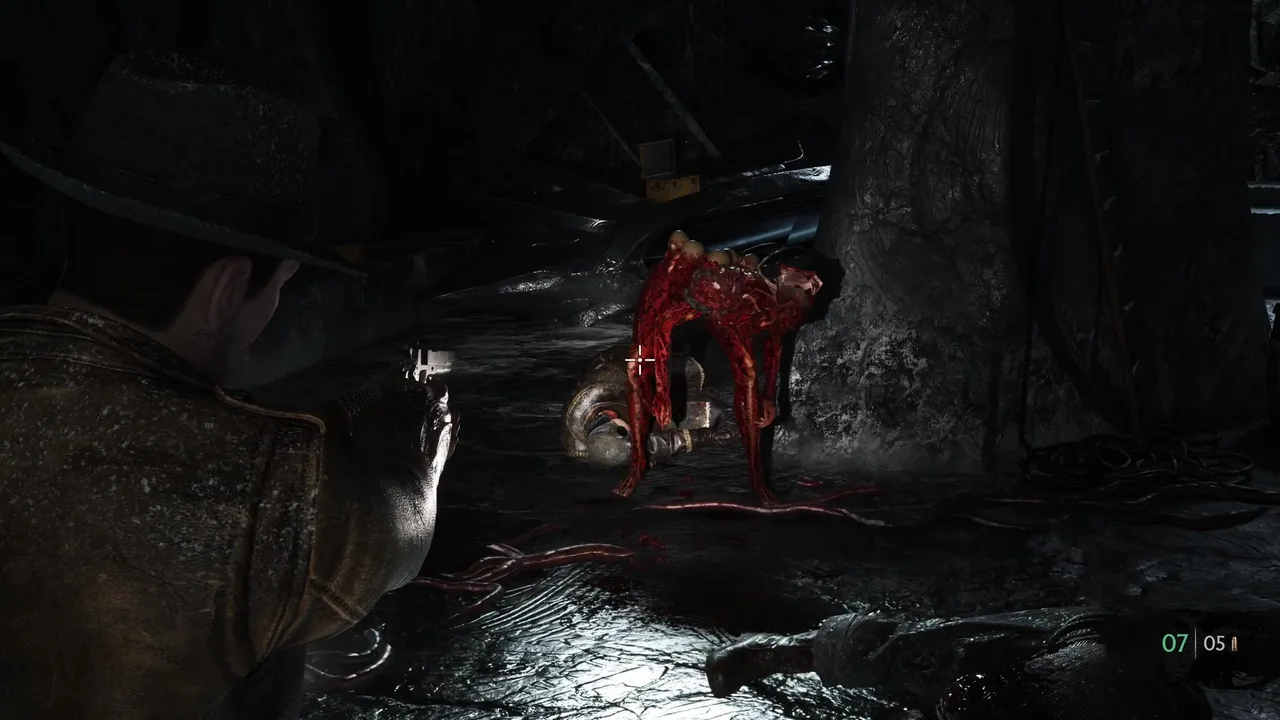 The protagonist firing at a red tentacled creature in a dark wet cave
